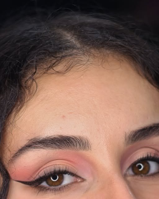Pink eyeshadow with a sharp winged eyeliner, occasion makeup by a London makeup artist